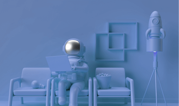 an astronaut sitting on a chair with a laptop and a popcorn bucket